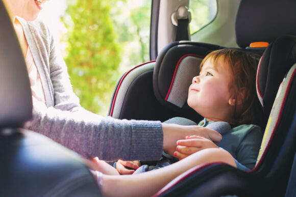 Toddler,girl,buckled,into,her,car,seat